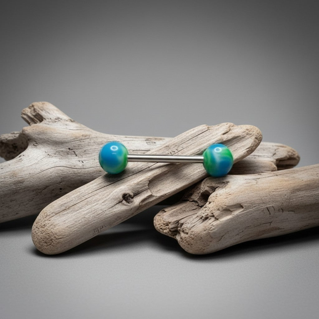 Aramat Jewels green and blue weed leaf tongue piercing made of surgical steel with marbled effect balls.