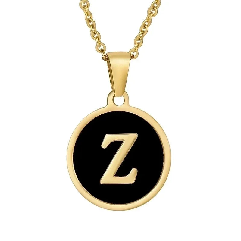 Gouden halsketting met de letter ’Z’ op een zwarte ronde achtergrond.