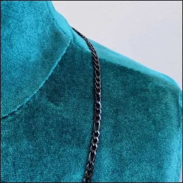 Een close-up van een zwarte ketting op een blauw shirt