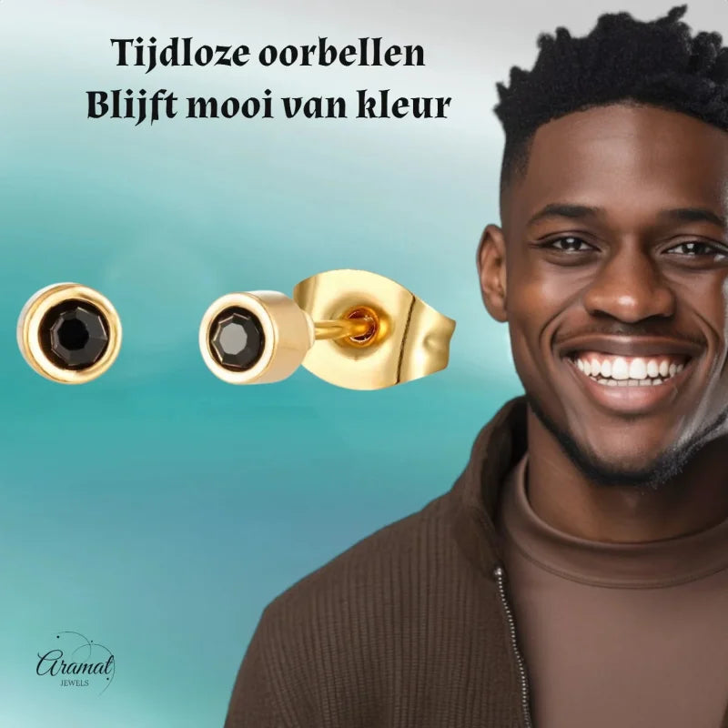 Gouden oorbellen met zwarte stenen.