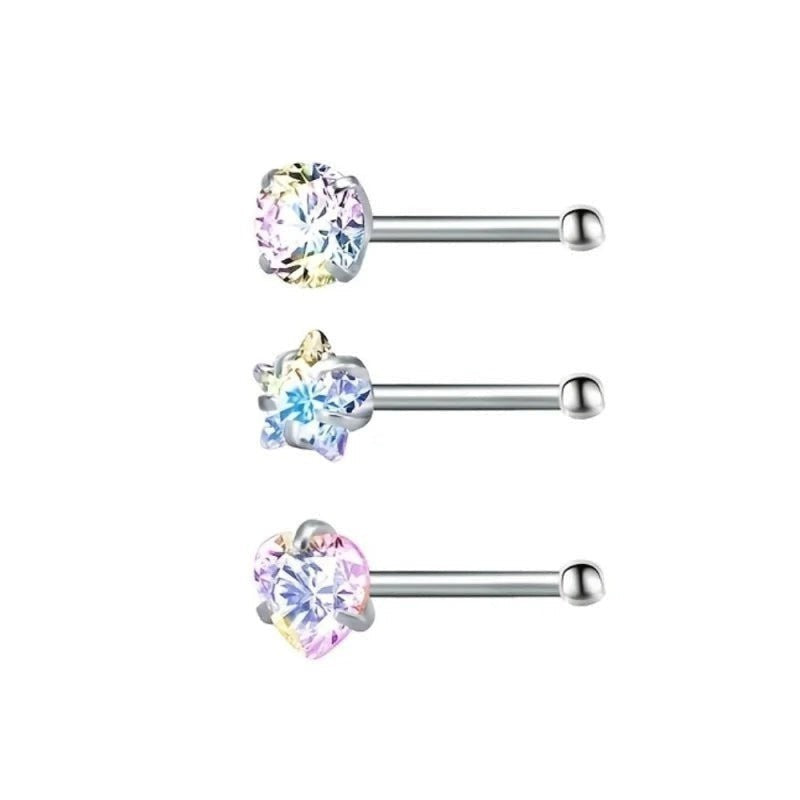 Drie verschillende gekleurde chirurgische piercings met een enkele kristallen steen