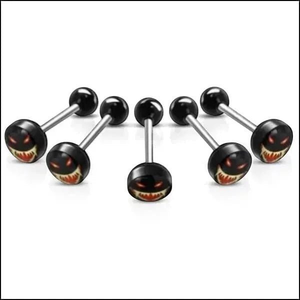 Aramat Jewels surgical steel tongue piercing with a black acrylic logo featuring a spooky face with red eyes and sharp teeth.