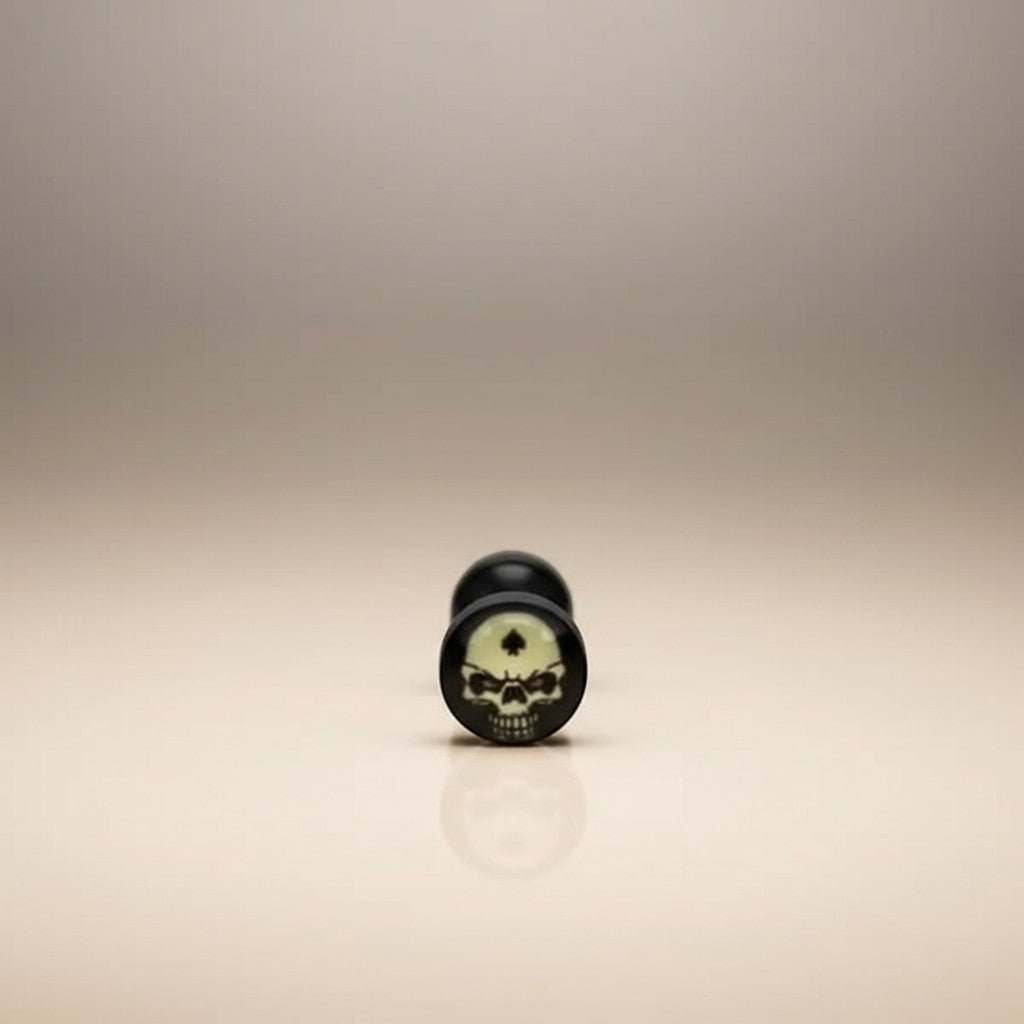 Aramat Jewels surgical steel tongue piercing with black acrylic logo featuring a skull design. Available in multiple colors.