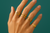 Woman's hand wearing multiple gold-colored adjustable rings