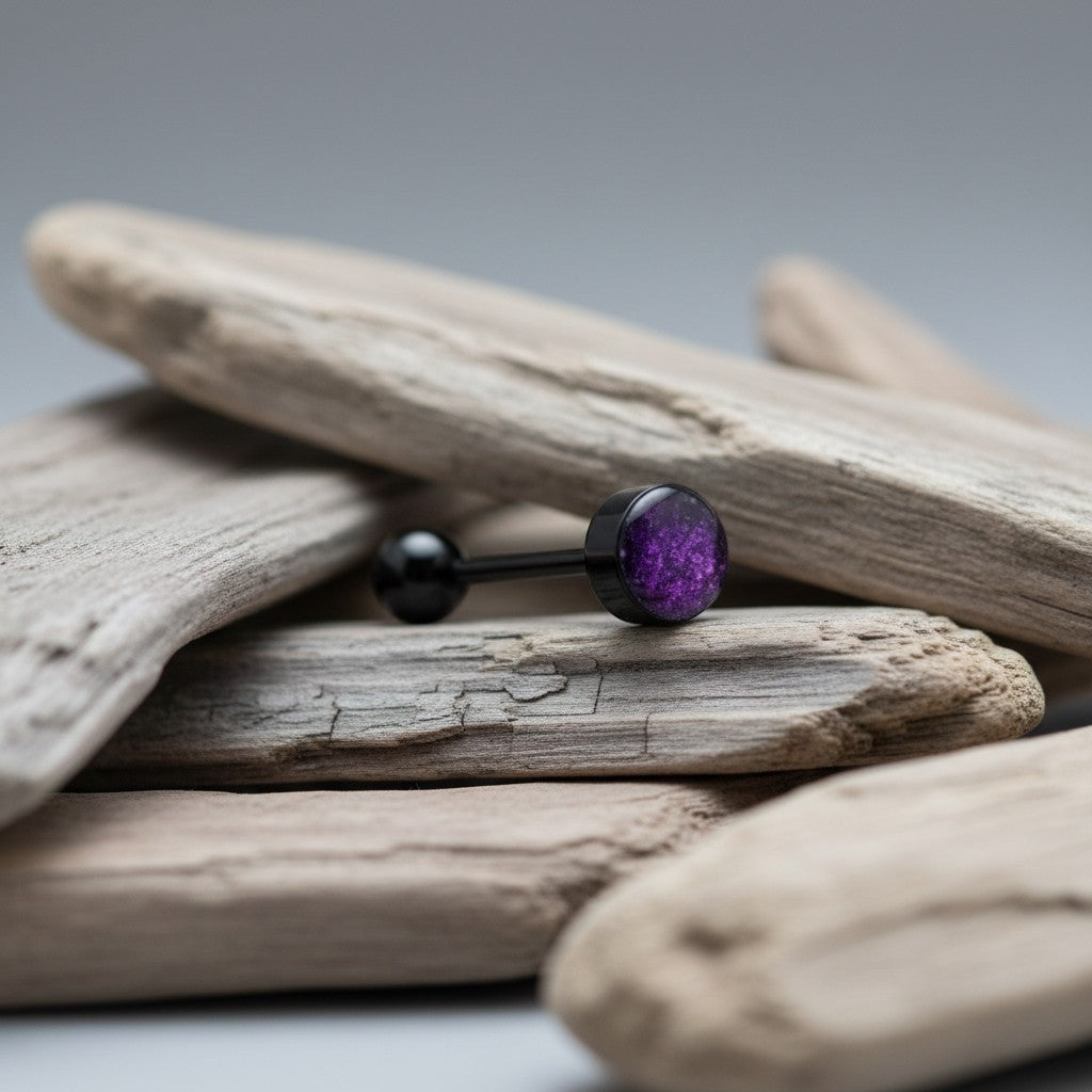 Aramat Jewels black bioplast tongue piercing with a glittery purple circular end and a black ball end.