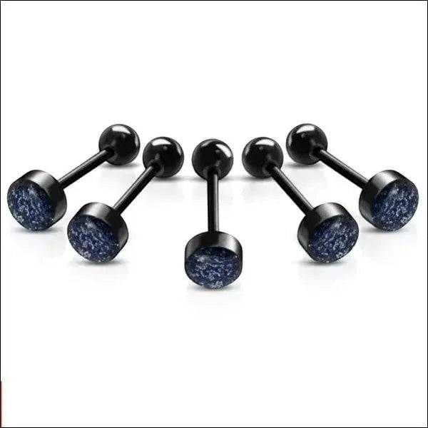 Een paar zwarte en blauwe glitterpiercings
